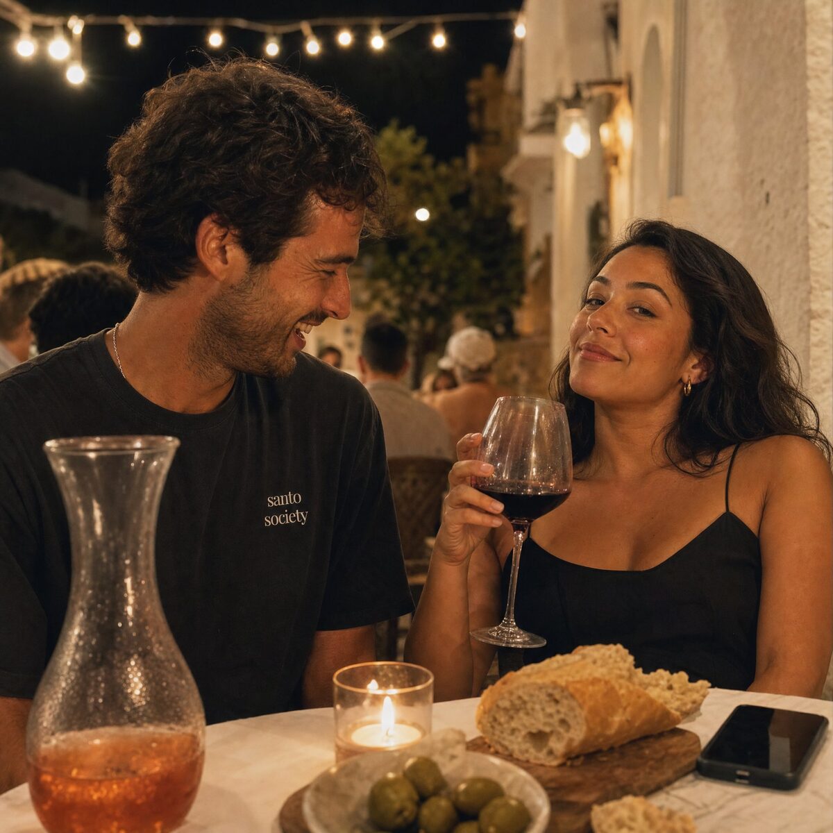Santo Society tee at a long Mediterranean dinner