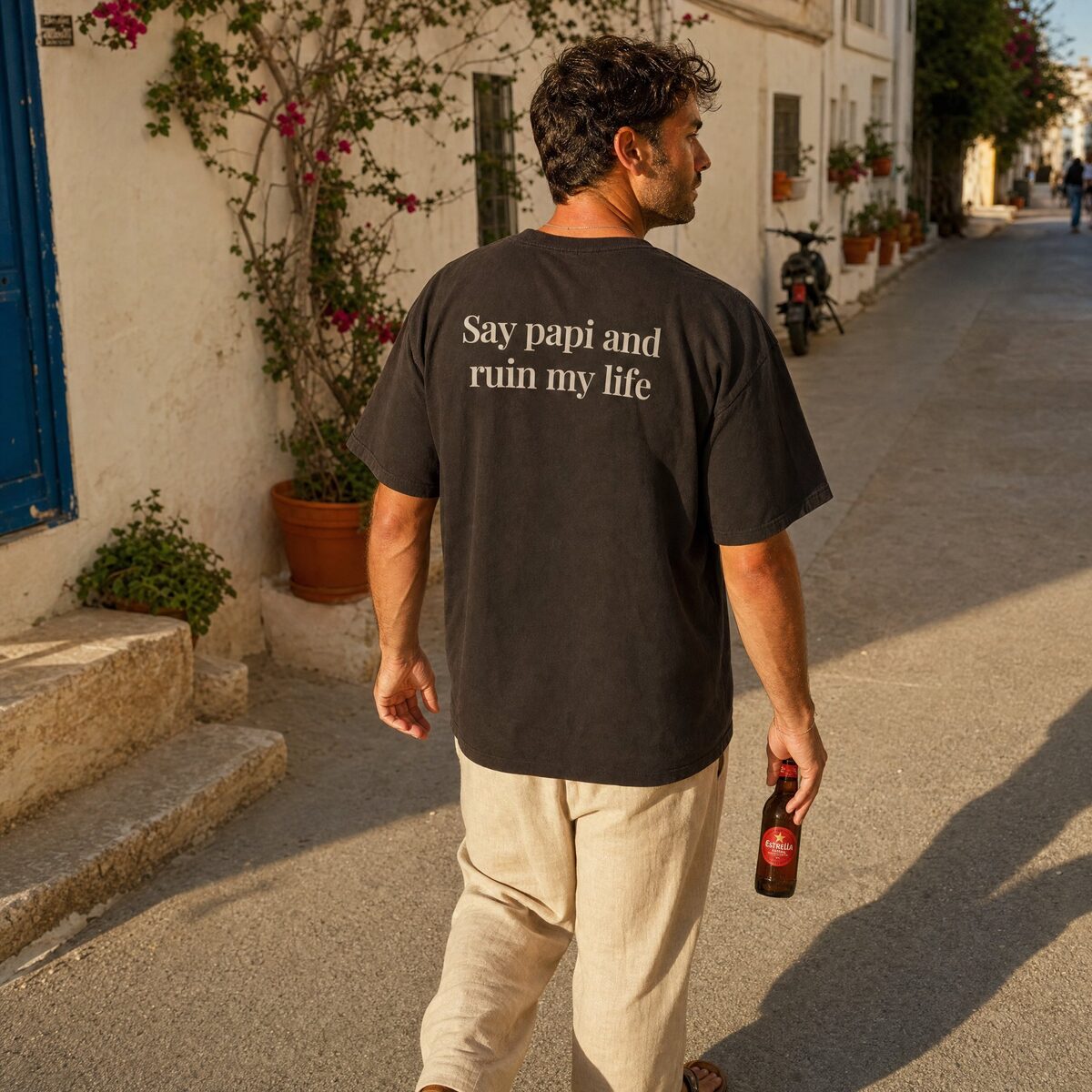Say papi and ruin my life, back print of the Santo Society heavyweight tee, worn in a Costa Blanca street